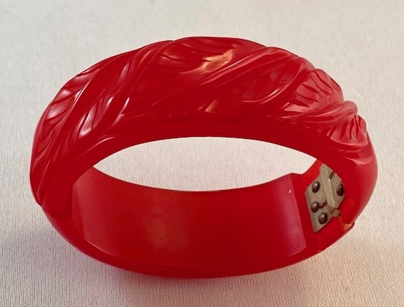 BB172 hinged leaf carved red jello bakelite bracelet